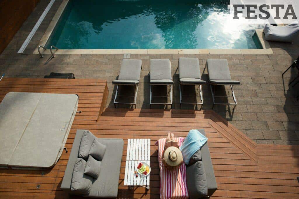 four gray loungers near pool
