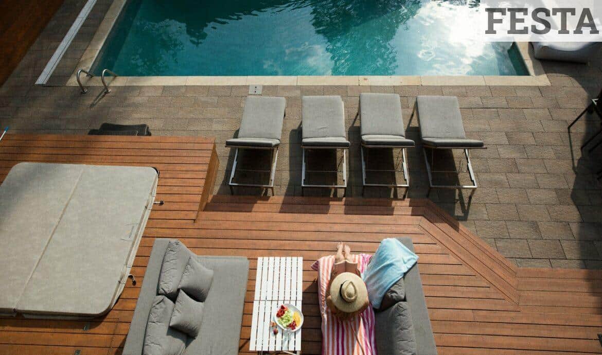 four gray loungers near pool