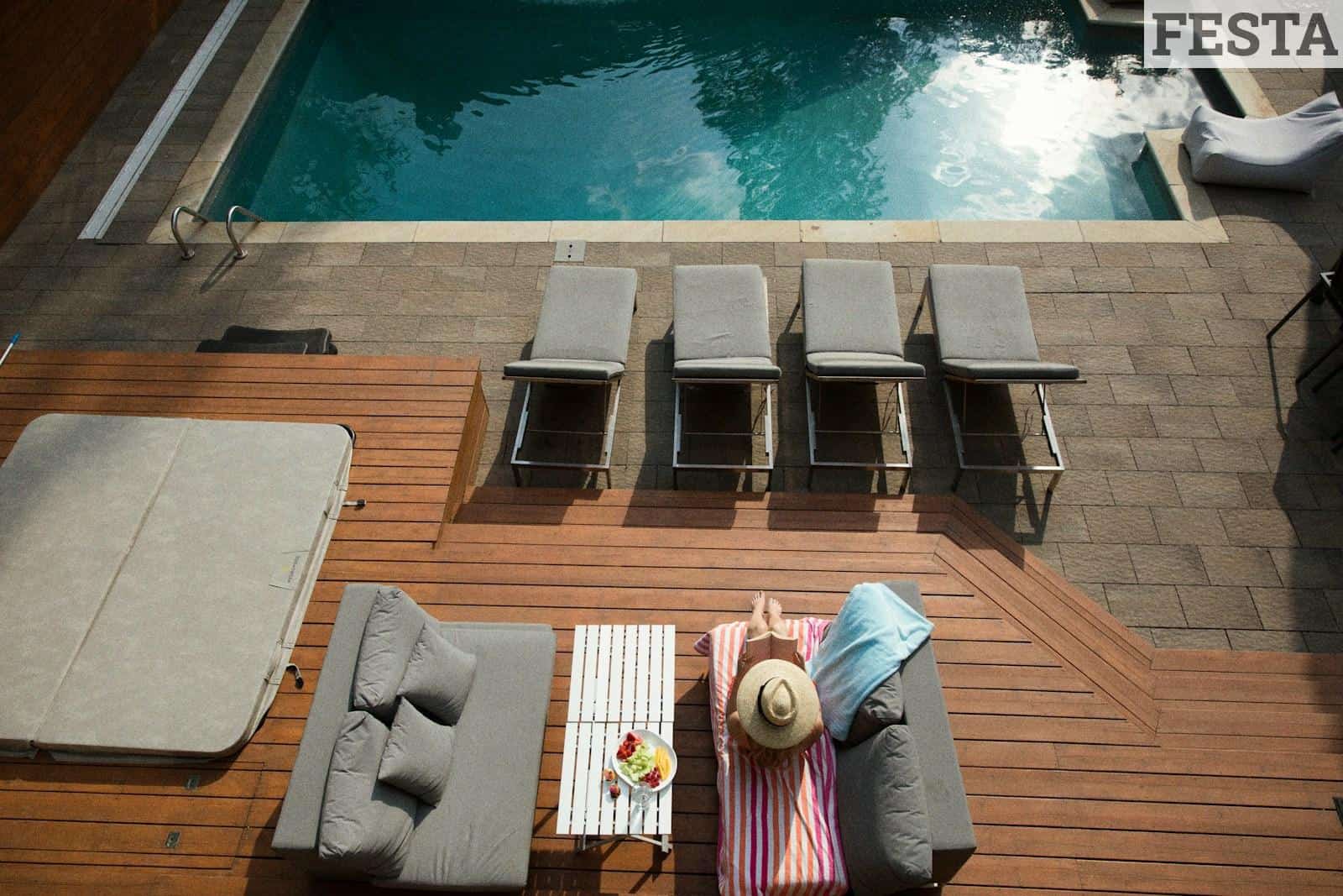 four gray loungers near pool